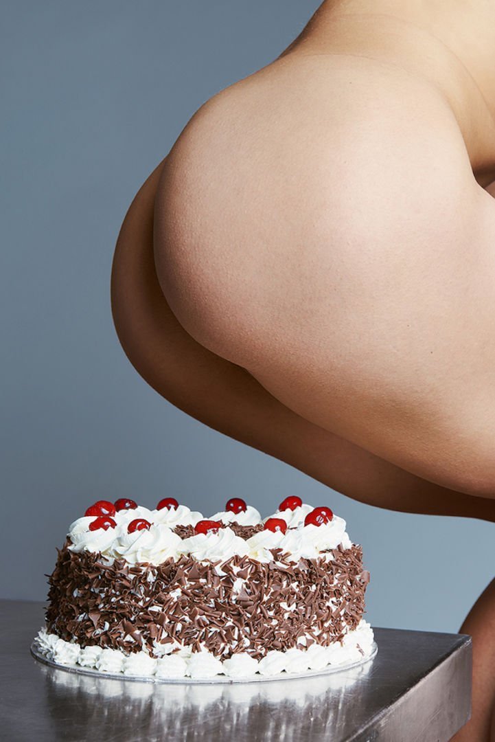 Nude girl erotic sitting on cake